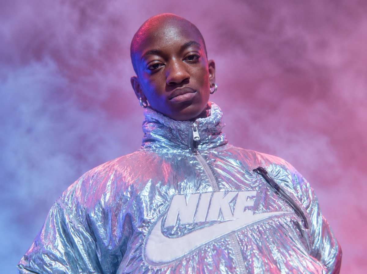AI Prompt for Cyberpunk Fashion Portrait with Metallic Branded Puffer Jacket