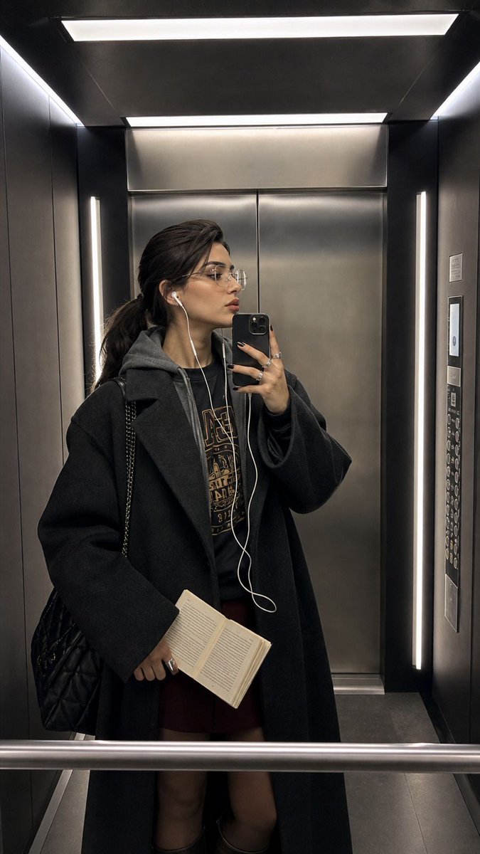 Modern iPhone Mirror Selfie – Young Woman in Sleek Elevator