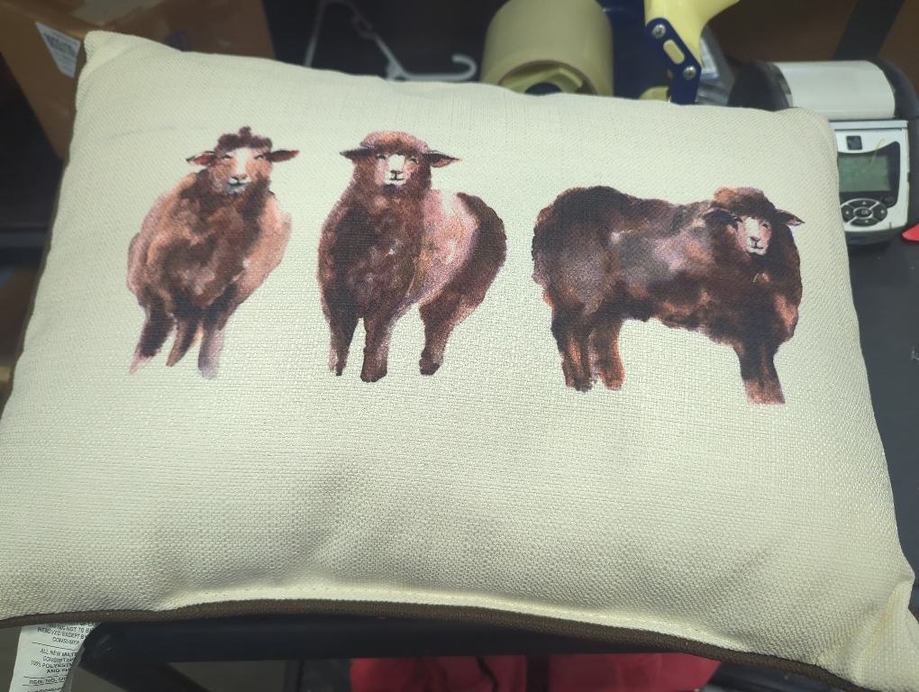 throw pillow with 3 sheep painted on