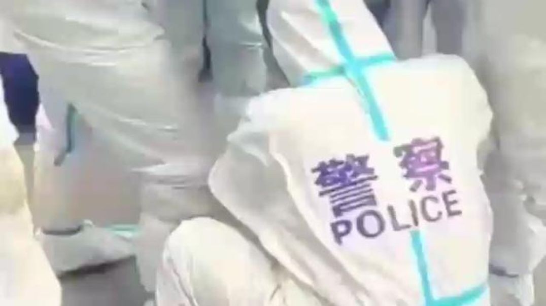 Chinese Police tape man up during lockdown.