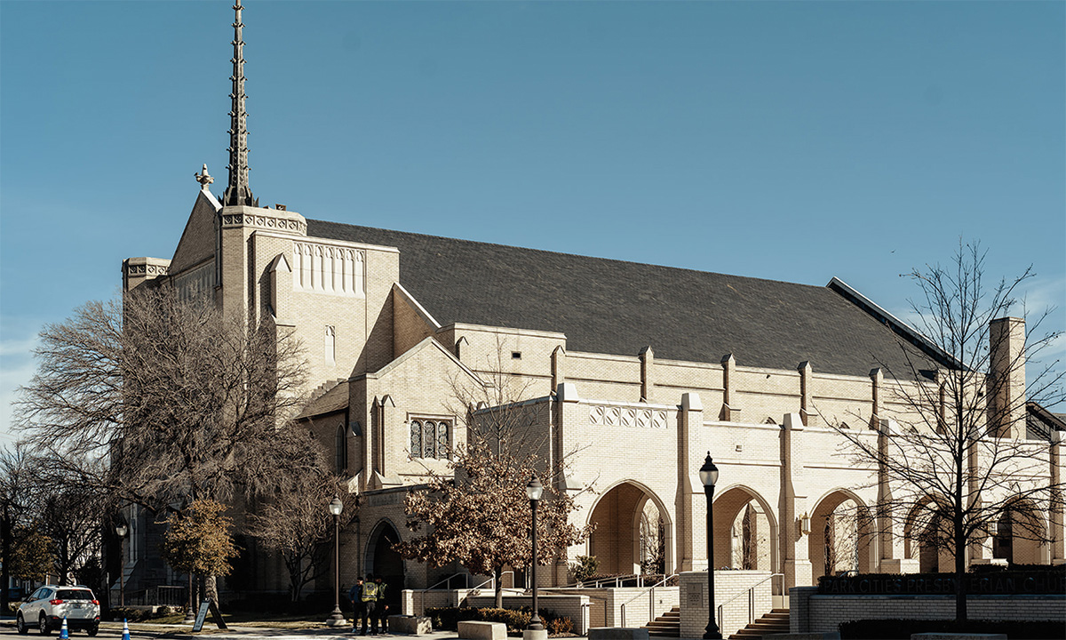 Exterior view of the Park Cities Presbyterian Church sanctuary building with tall steeple and arched entrances.