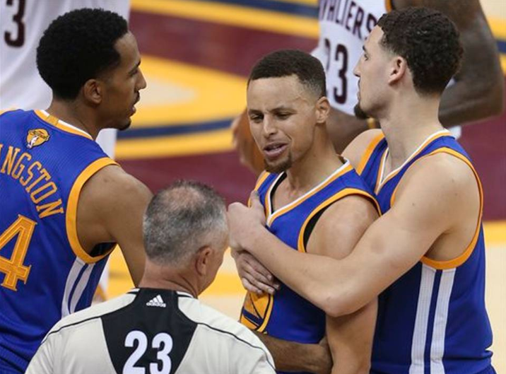 Golden State Warriors guard Stephen Curry is held back from referee Jason Phillips (23) by Shaun Livingston, left, and Klay Thompson, right, while reacting to being called for his sixth foul on Cleveland Cavaliers forward LeBron James (23) during the second half of Game 6 of basketball's NBA Finals in Cleveland, Thursday, June 16, 2016. Ron Schwane AP Photo