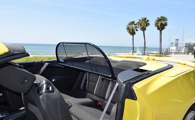 Camaro convertible wind deflector fits 2016 to 2024 at the beach in la closeup of wind deflector manufacturered by love the drive.